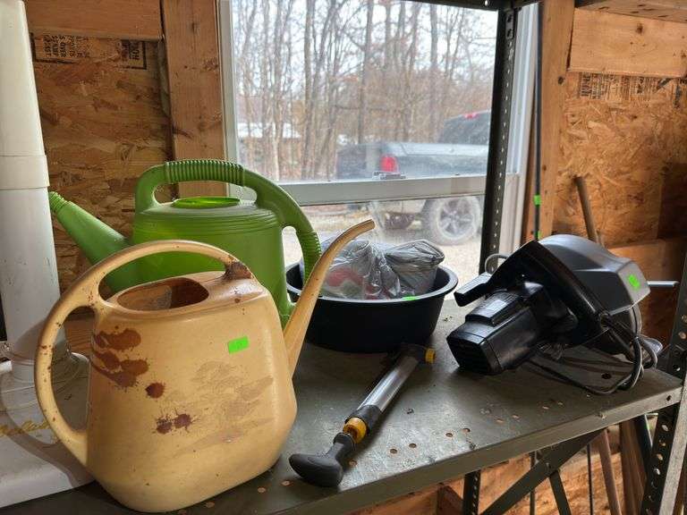 Contents of shelf saw and watering cans