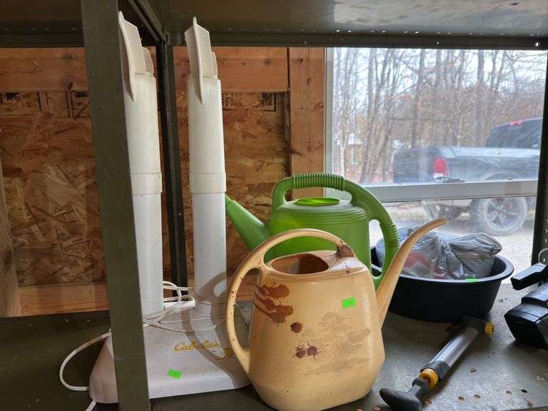 Contents of shelf saw and watering cans