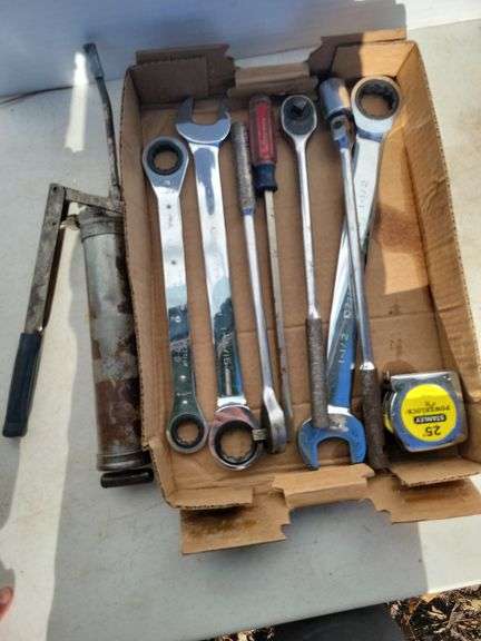Large wrenches, ratchets, screwdriver, tape, grease gun