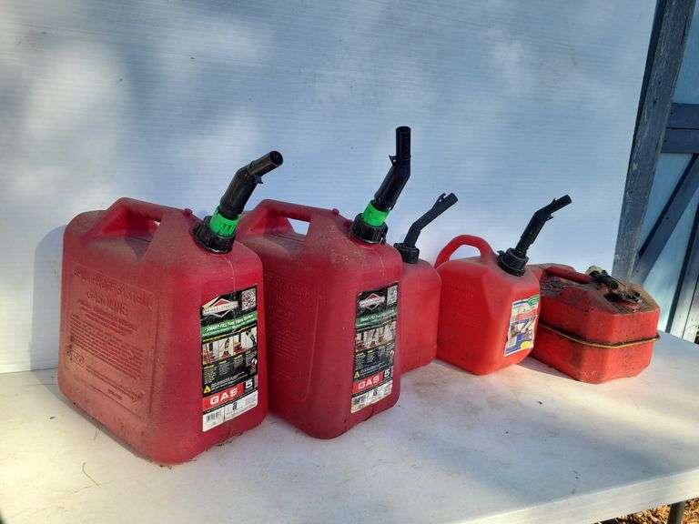 (2) 5 gallon & 3 other fuel cans/ some have fuel in them