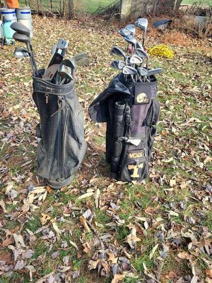 (2) golf bags with various clubs