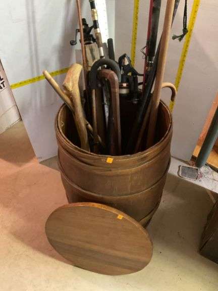 Nail Keg with Fishing Poles, Canes, Axe Handle, Dry Wall Square