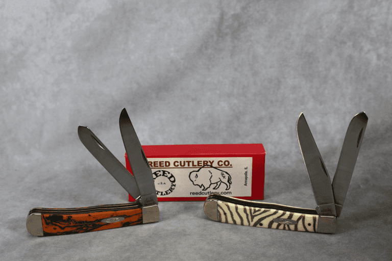 2004 CASE TRAPPERS; ORANGE SWIRL SYNTHETIC 3254 AND NATURAL BONE ZEBRA STRIPES 6254