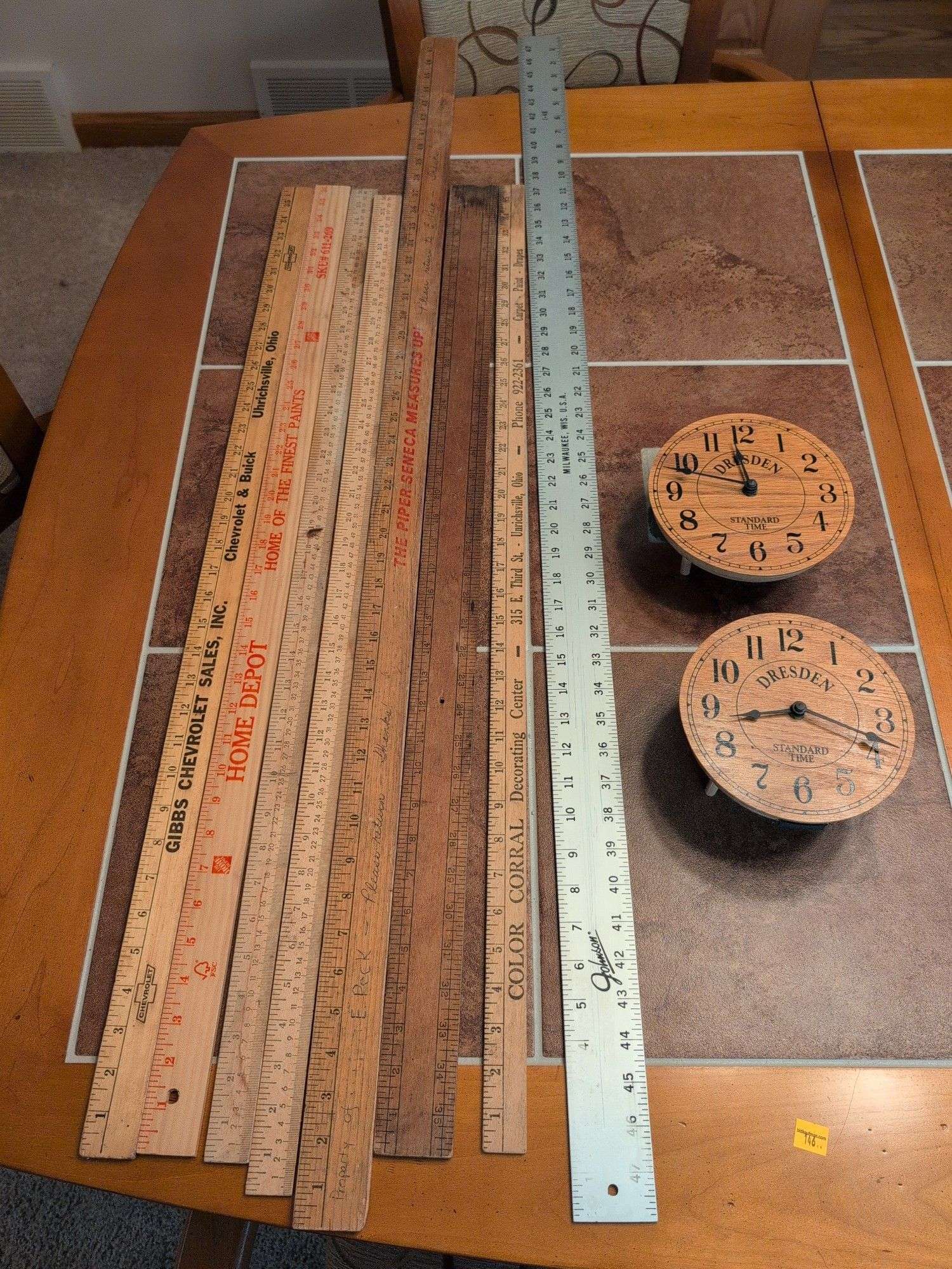 Advertisement yard sticks and (2) Dresden clocks