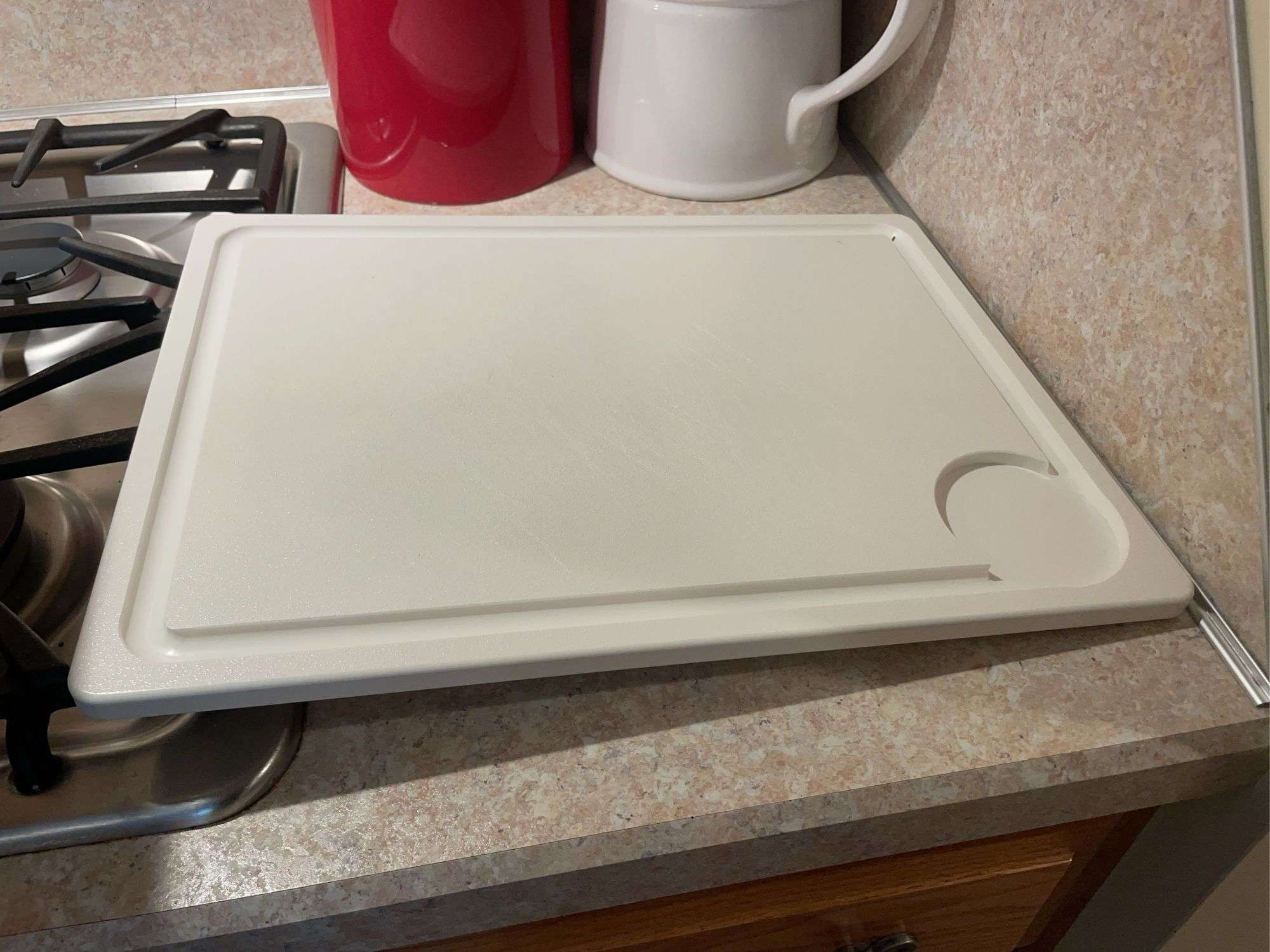 Cutting board and crock with miscellaneous kitchen utensils