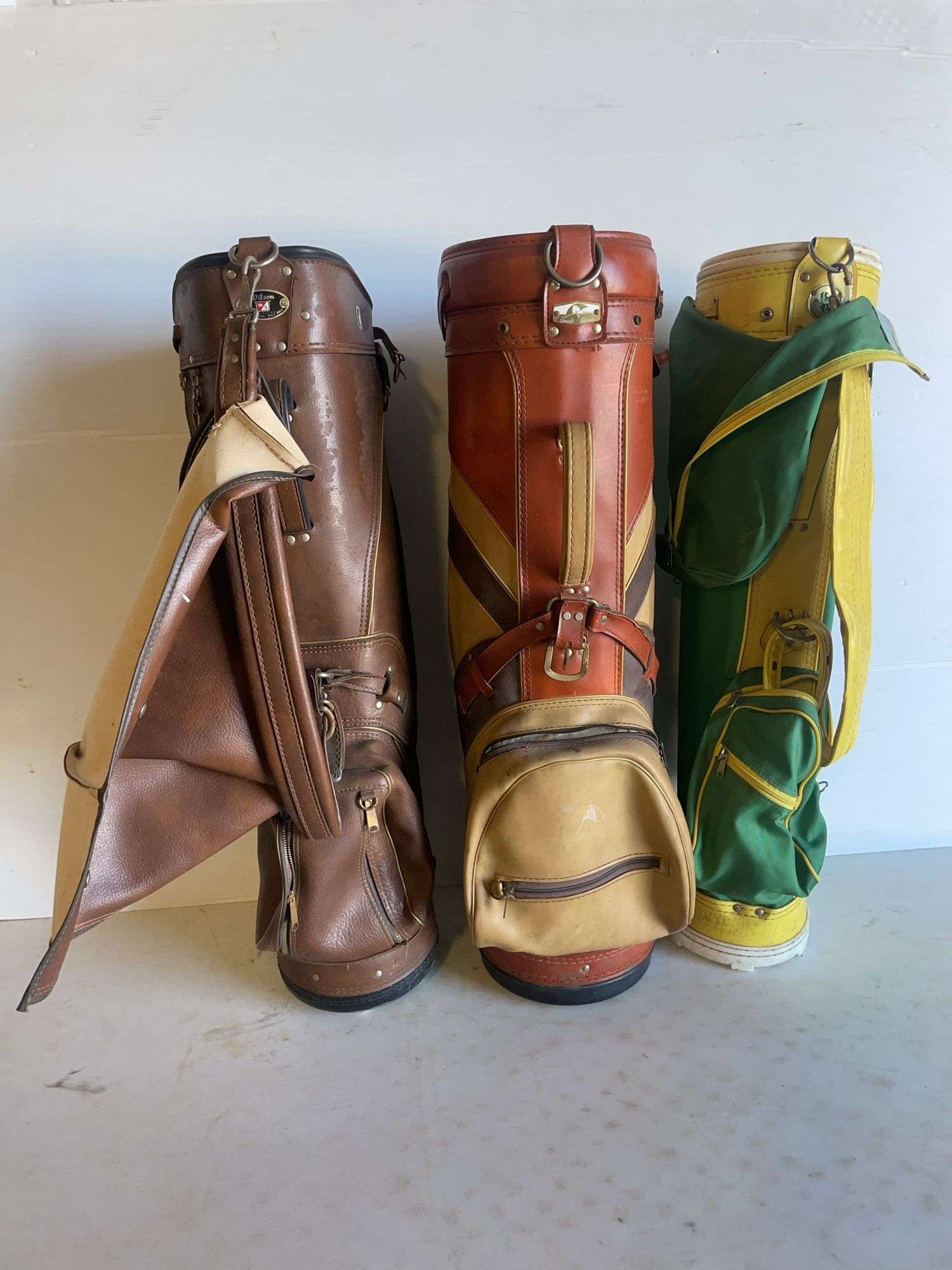 (3) vintage golf bags - Arnold Palmer, Wilson, and St. Andrews