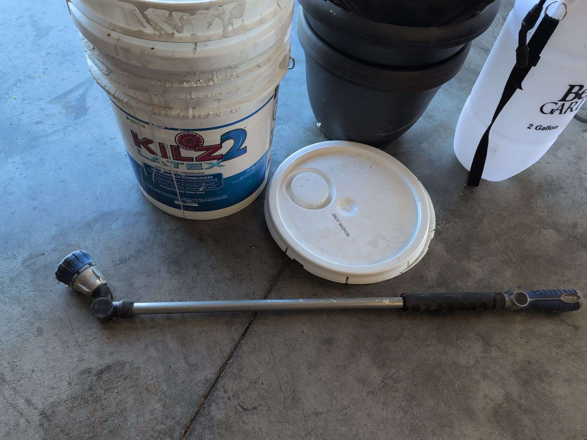 (2) 5 gallon buckets with lids, flower pots, sprayer, and hose nozzle