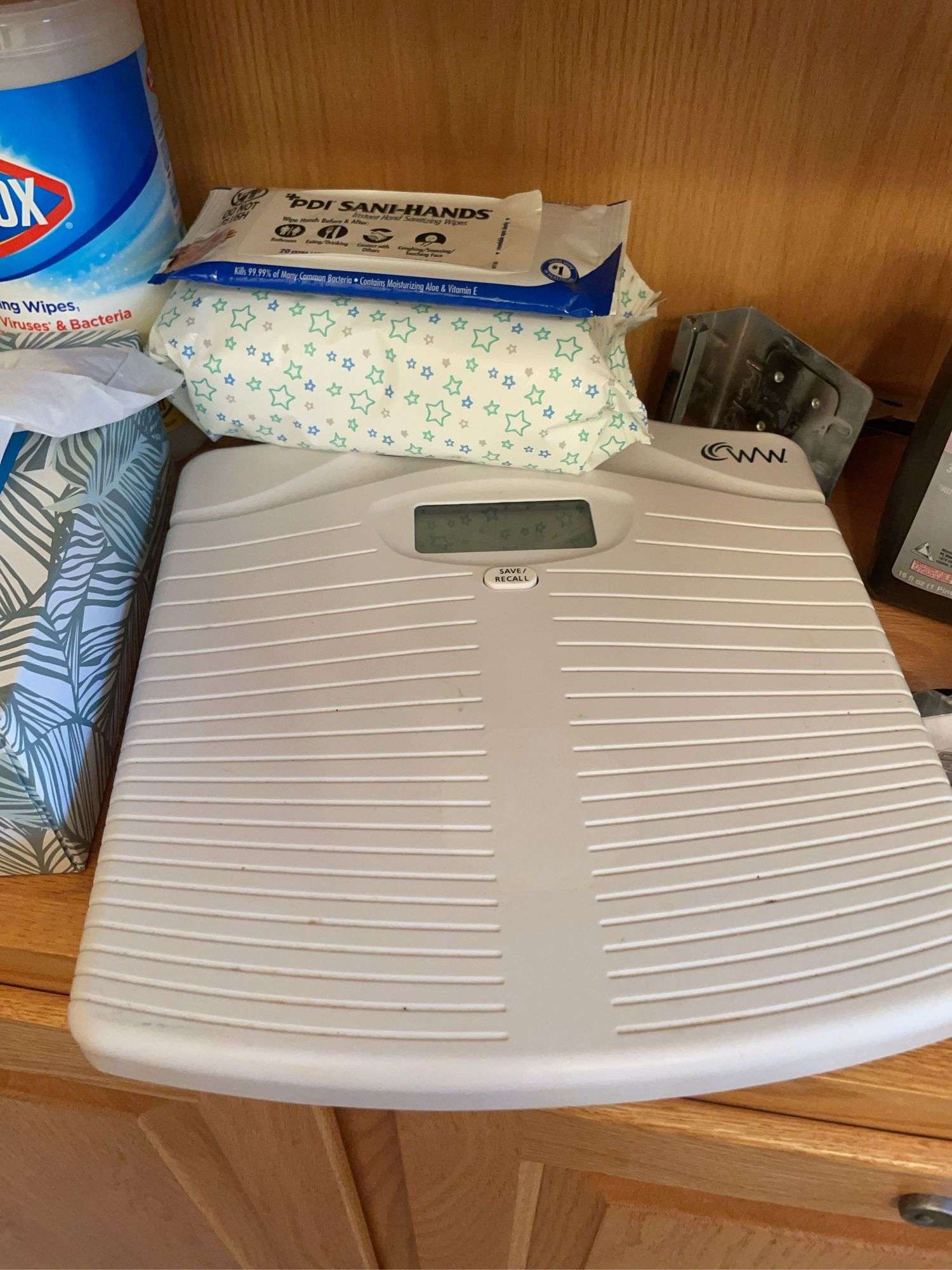 Shelf of bathroom contents - toiletries, cleaning supplies, and more