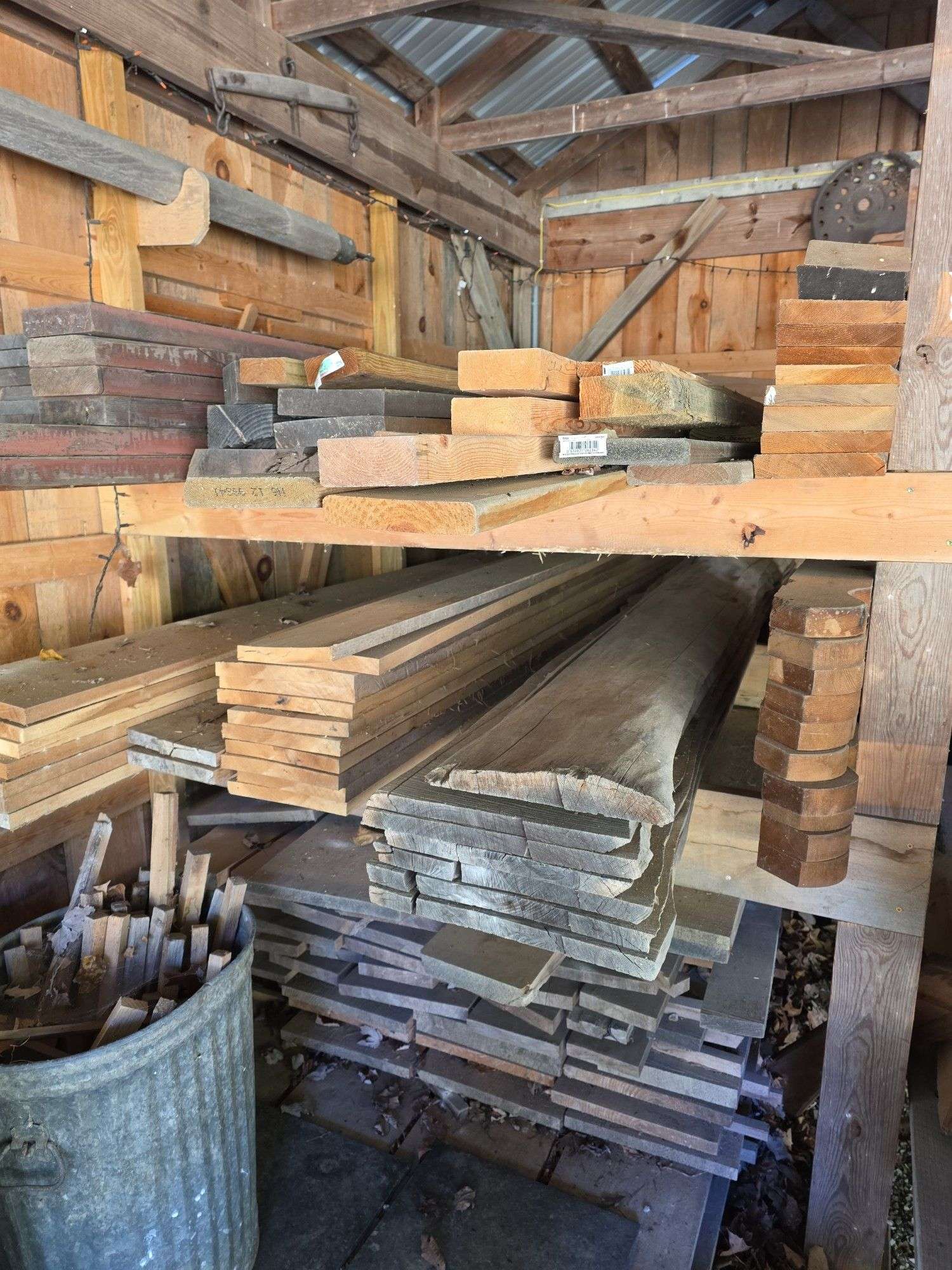 Assortment of stacked lumber. Under roof, lots of 8ft & 10ft variety of species Buyer responsible fo