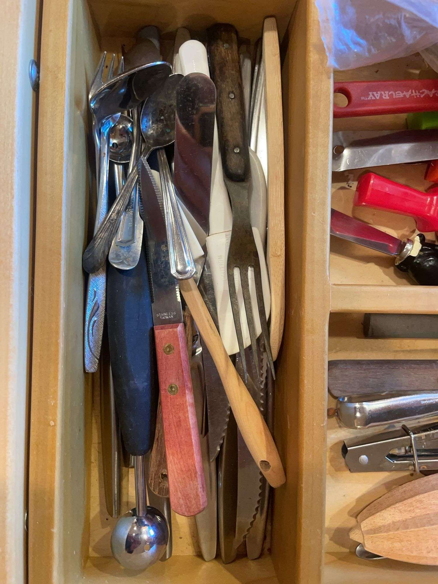 Contents of drawer including silverware, kitchen utensils & misc.