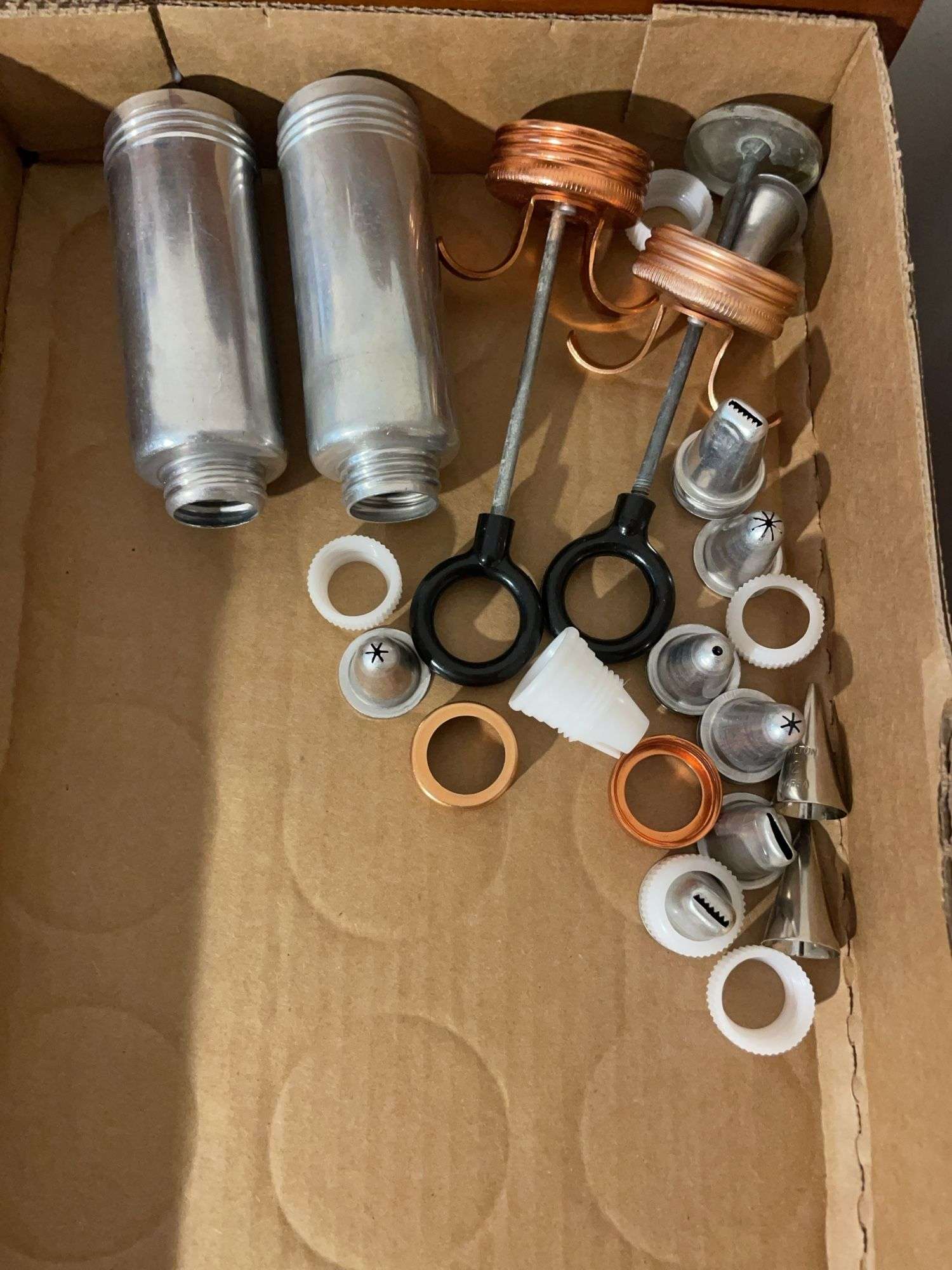 (2) flats of antique cookie cutters and icing dispensers
