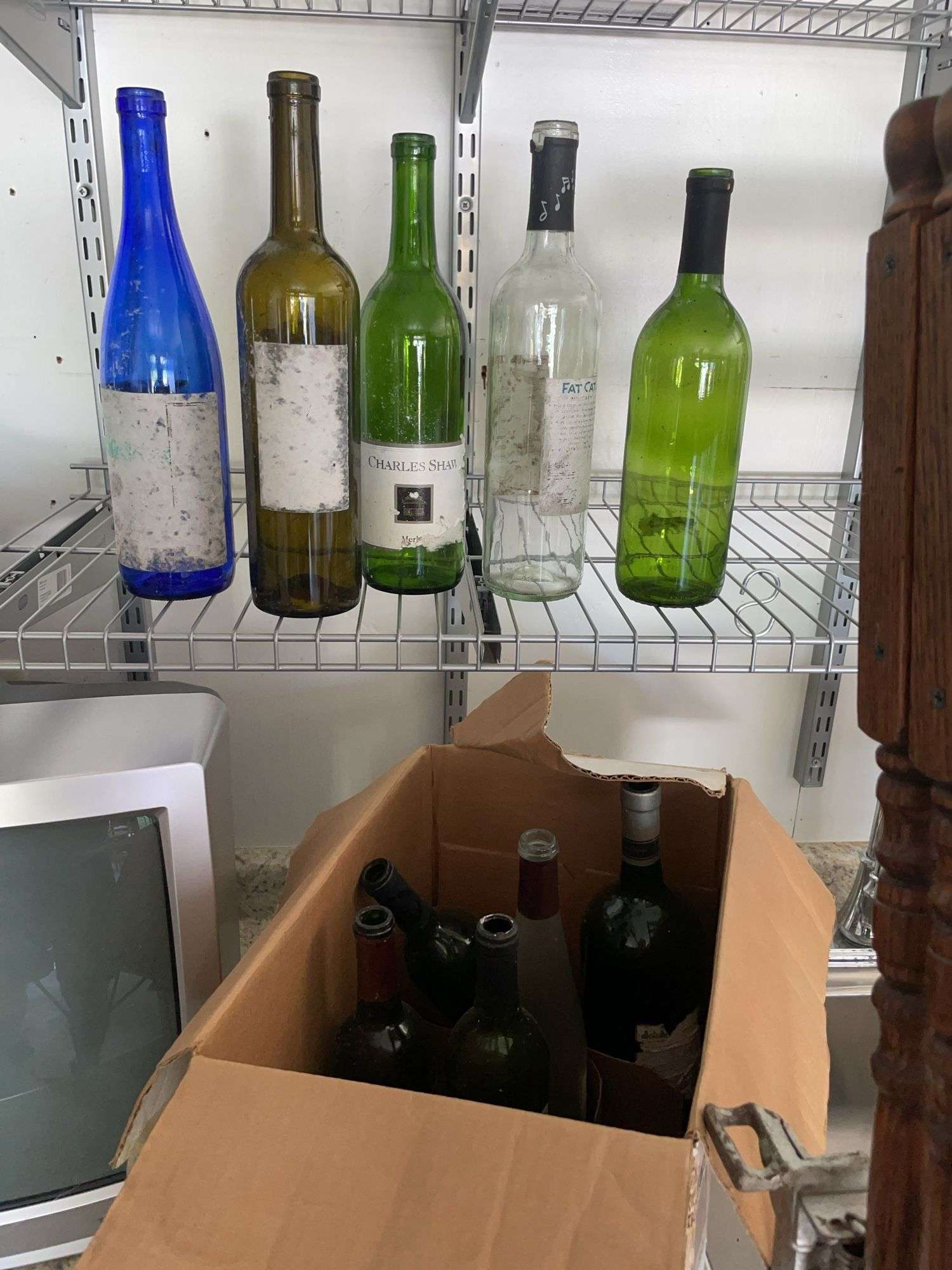 Box of empty wine bottles & decorative rack