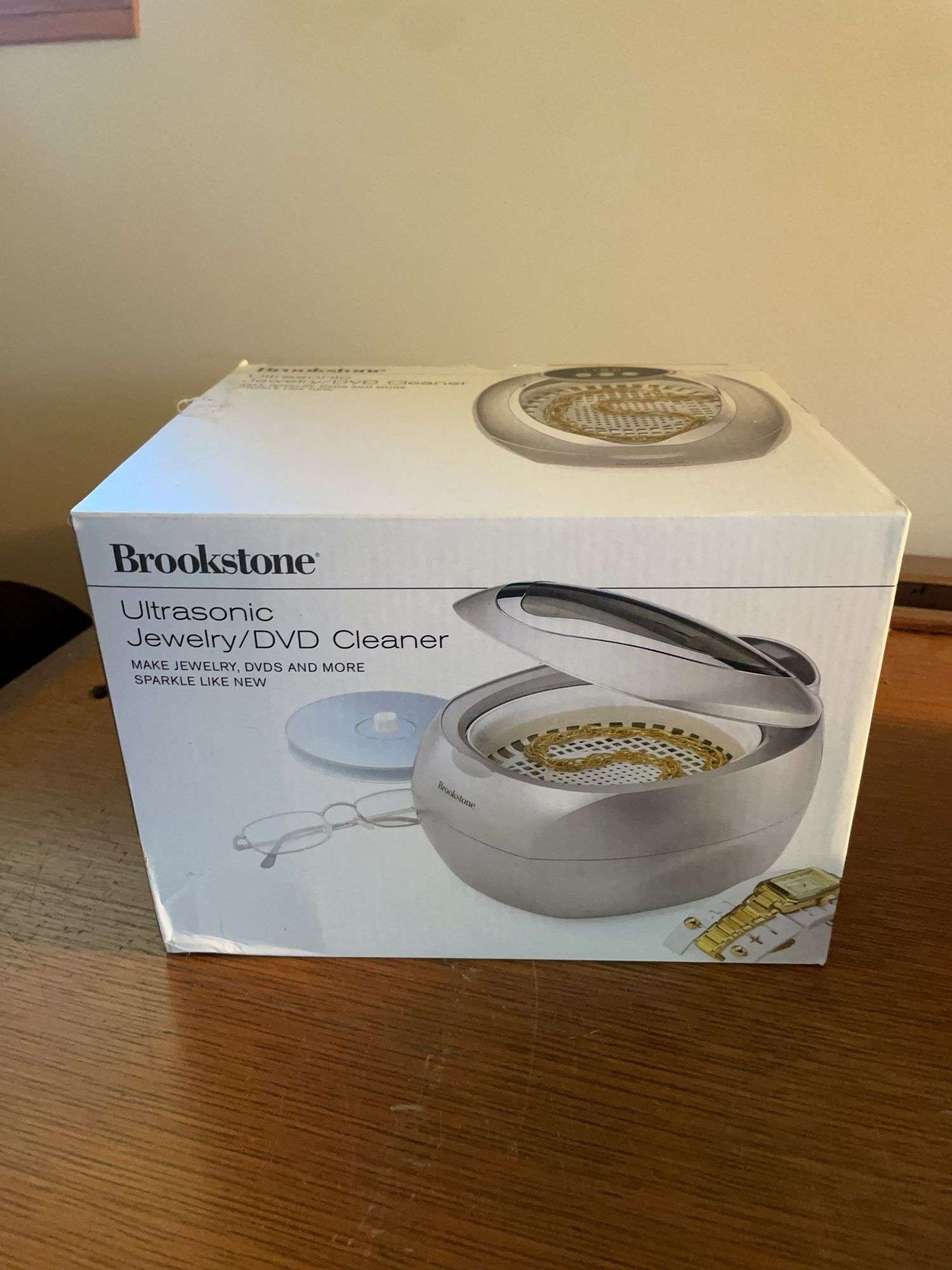 Flat of costume jewelry - mostly bracelets and earrings, and jewelry cleaner