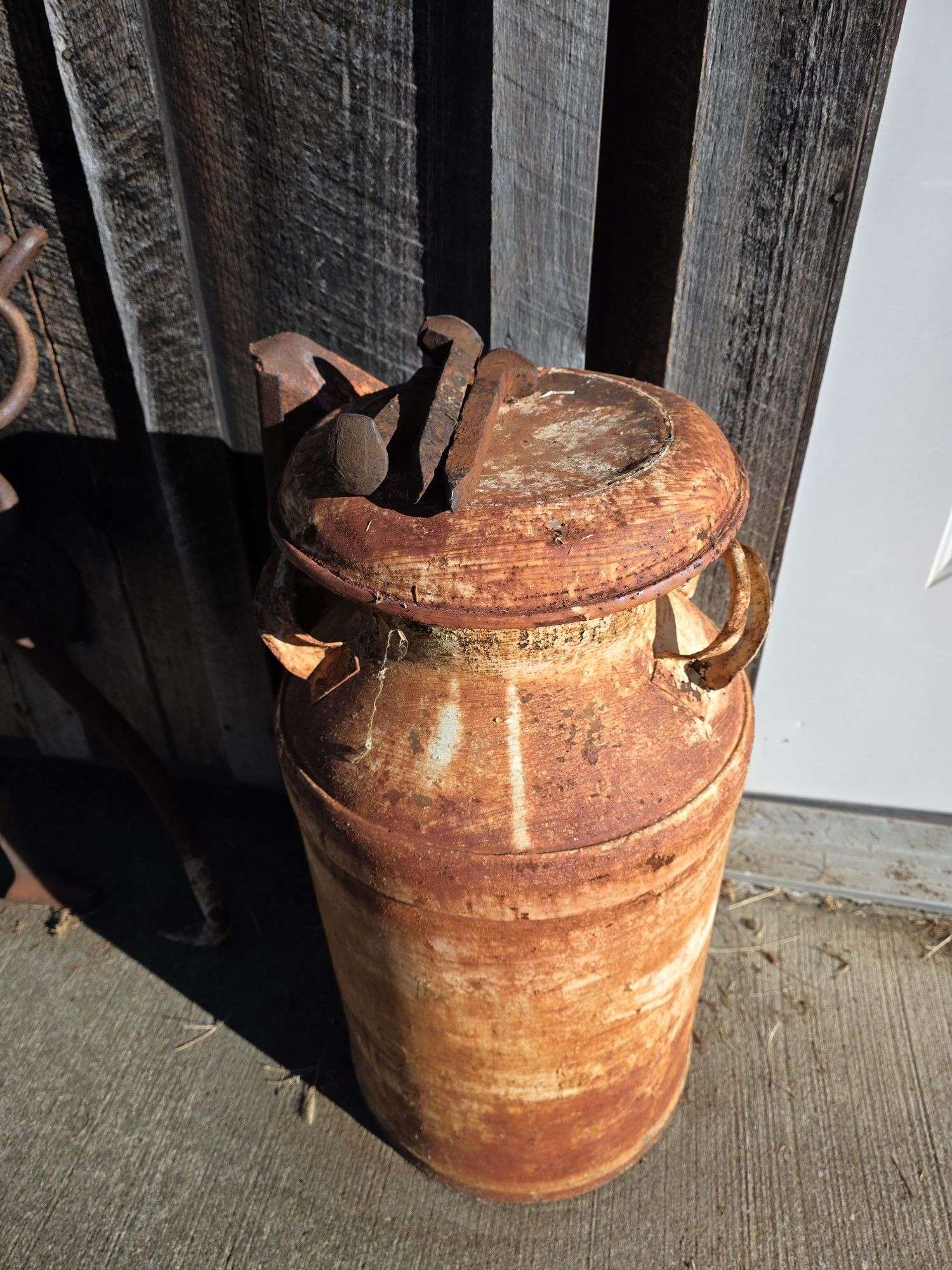 Milk can, cast bench, end tongs