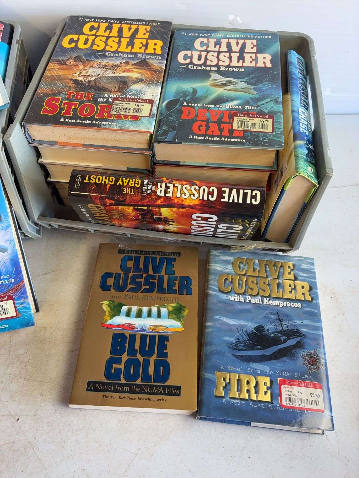 Large assortment of Clive Cussler books and other books