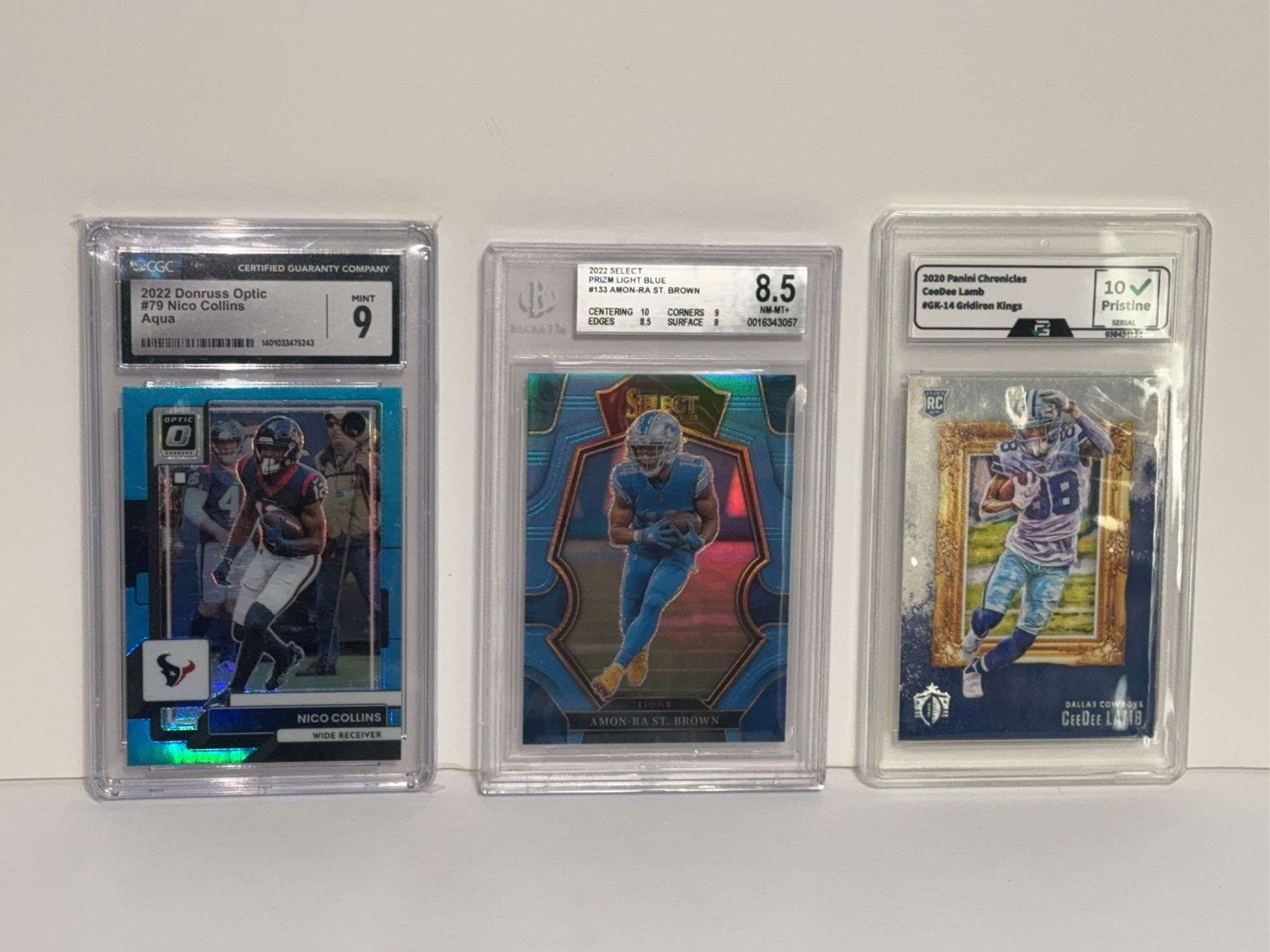 2022 Donruss Optic Nico Collins Aqua (CGC 10), 2022 Select Amon Ra St. Brown Prizm Light Blue (BGS 8