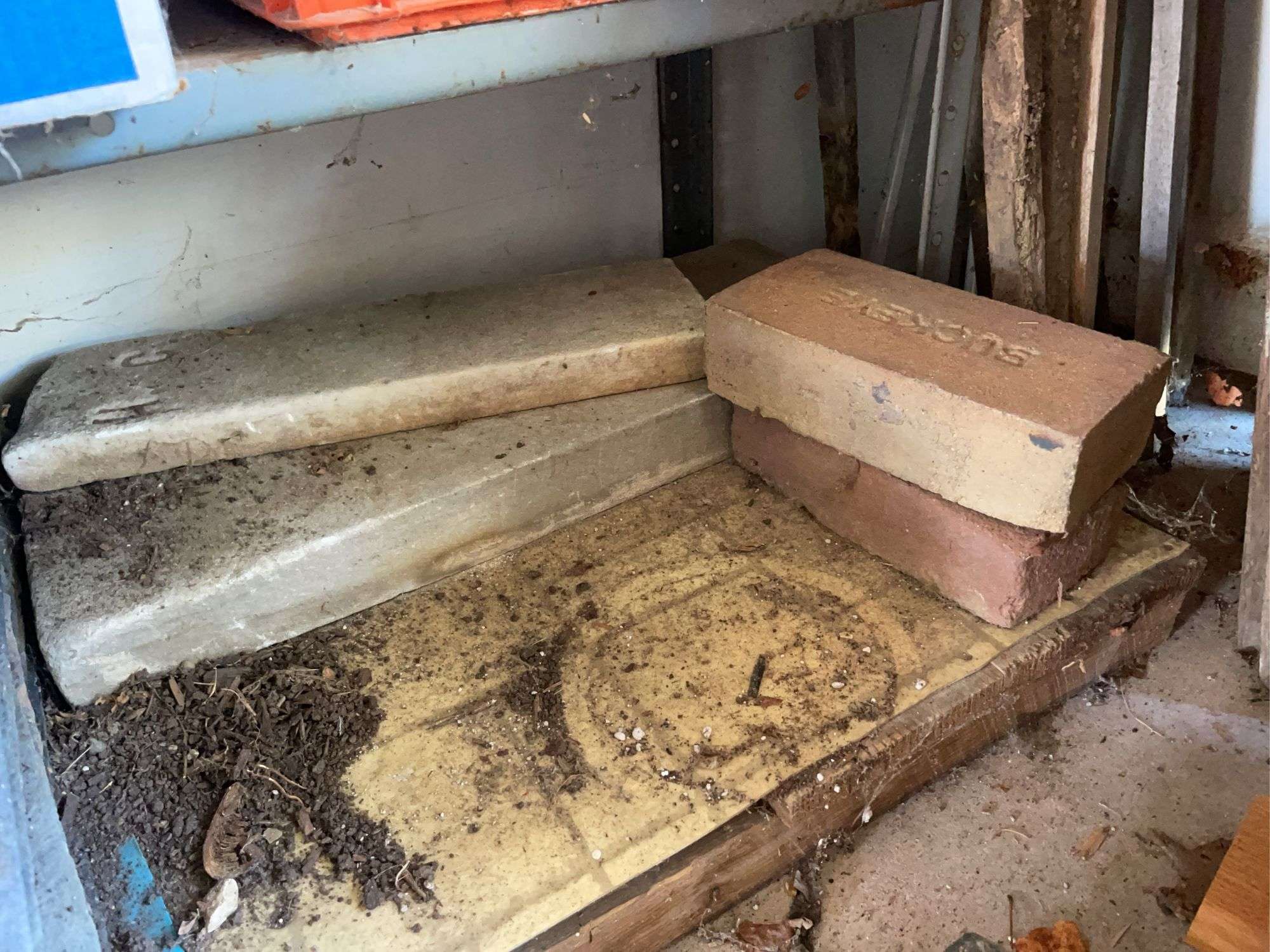 Metal storage shelf w/ slate pieces & bricks