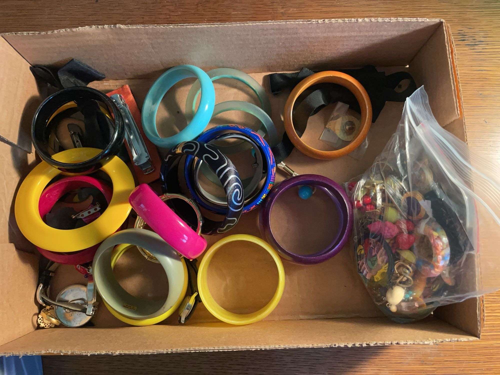 Flat of costume jewelry - mostly bracelets and earrings, and jewelry cleaner