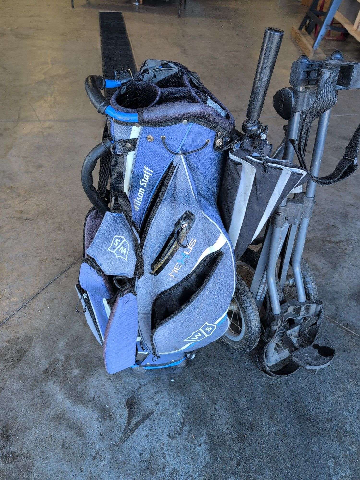 Wilson Staff golf bag and Sun Mountain bag carrier