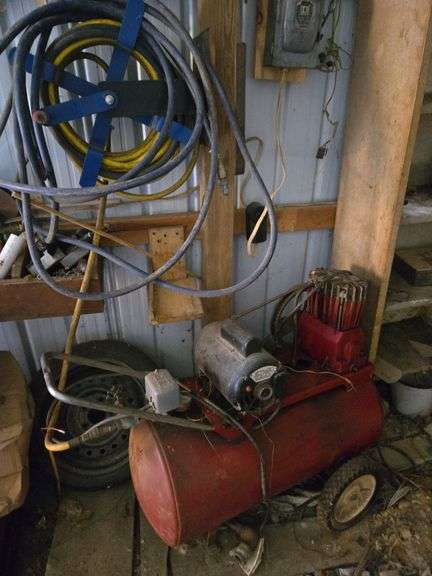 Air compressor w/ air hose- reel fastened to wall