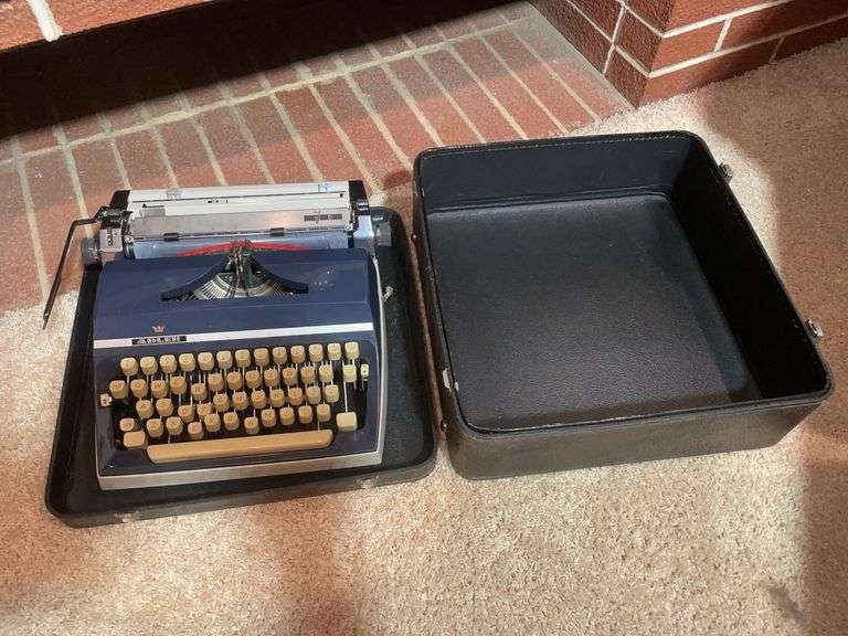 Antique Adler typewriter with case
