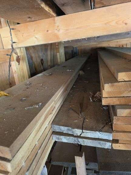 Assortment of stacked lumber. Under roof, lots of 8ft & 10ft variety of species Buyer responsible fo