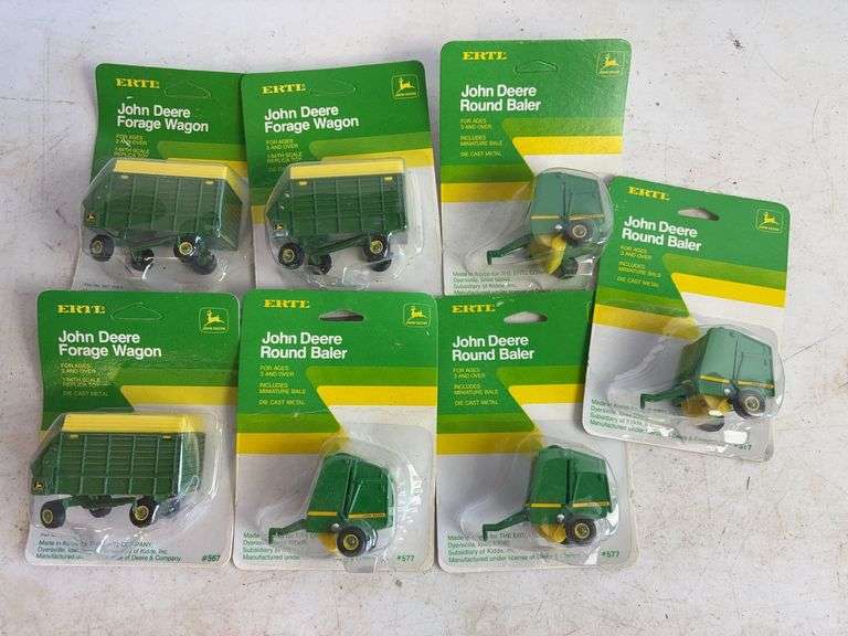 (7) John Deere diecast model toys - (3) forage wagons and (4) round balers