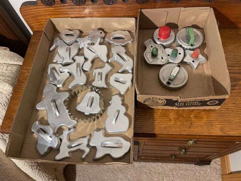 Green and red handled cookie cutters and others