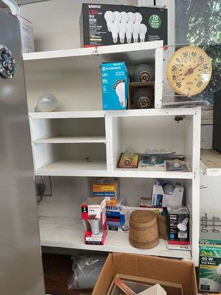 Contents of shelving including lightbulbs, screw-in hooks & more