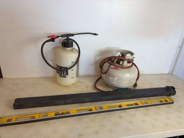 Propane tank with torch, deck sprayer, and level