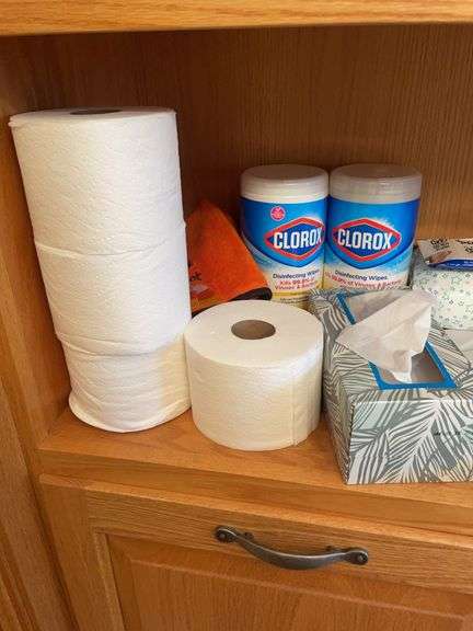 Shelf of bathroom contents - toiletries, cleaning supplies, and more