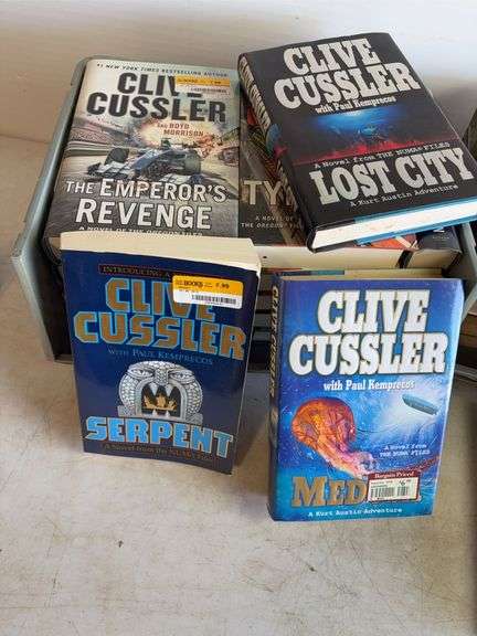 Large assortment of Clive Cussler books and other books