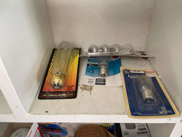 Contents of shelving including lightbulbs, screw-in hooks & more