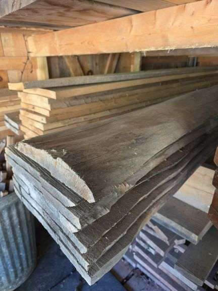Assortment of stacked lumber. Under roof, lots of 8ft & 10ft variety of species Buyer responsible fo