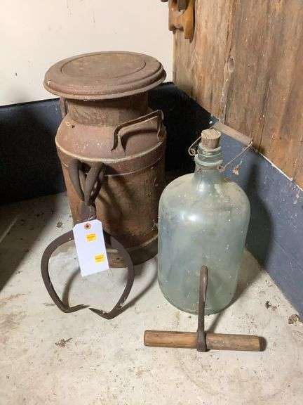 Ice tongs, hog hook, milk can, & tall glass jug