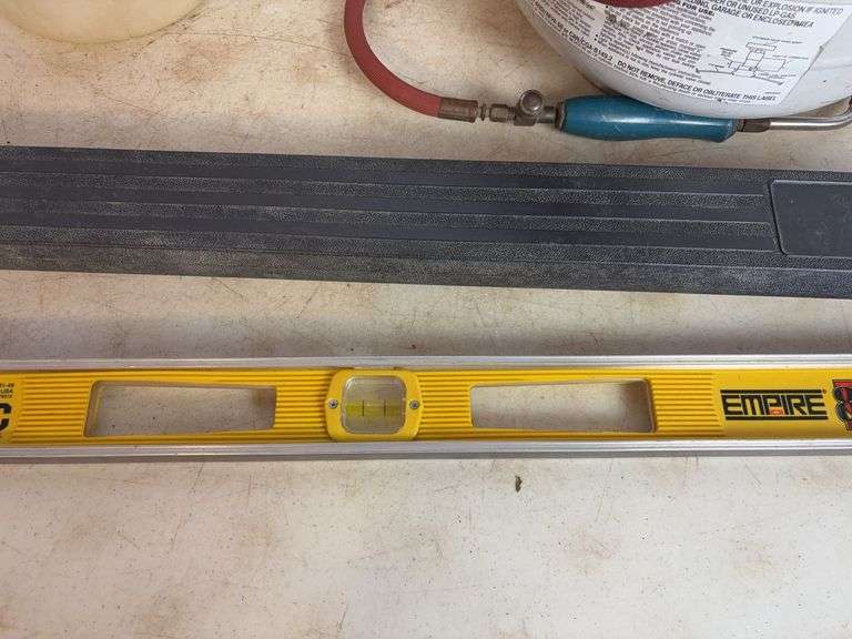 Propane tank with torch, deck sprayer, and level