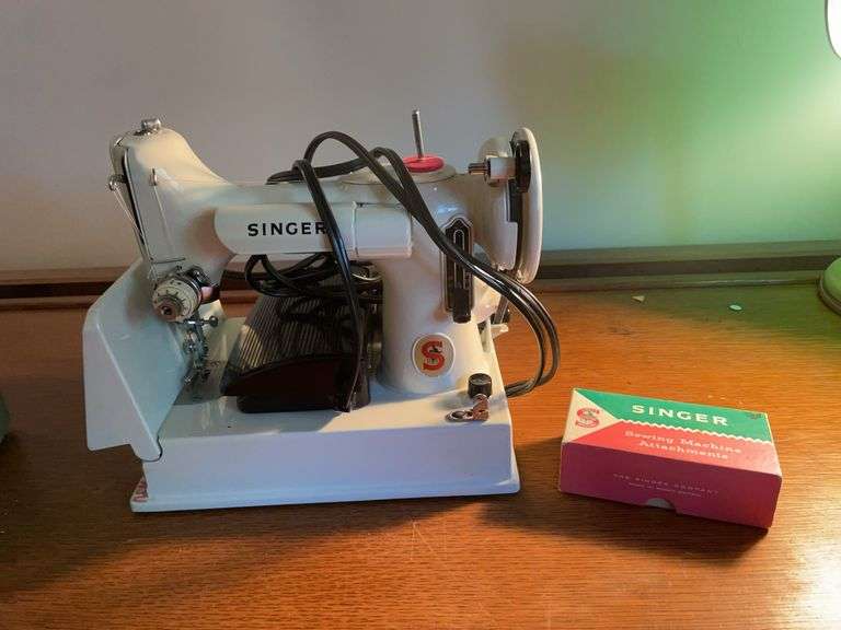 Singer sewing machine with attachments