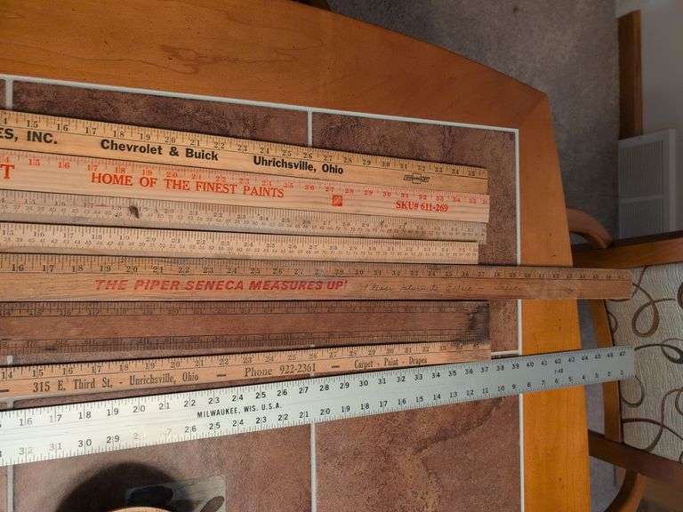 Advertisement yard sticks and (2) Dresden clocks