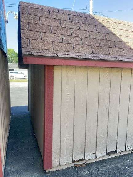 10x12 tan and red storage barn - contents not included