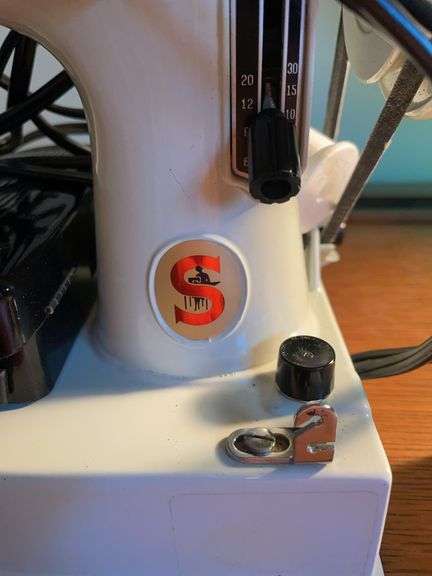 Singer sewing machine with attachments