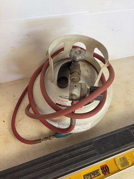 Propane tank with torch, deck sprayer, and level