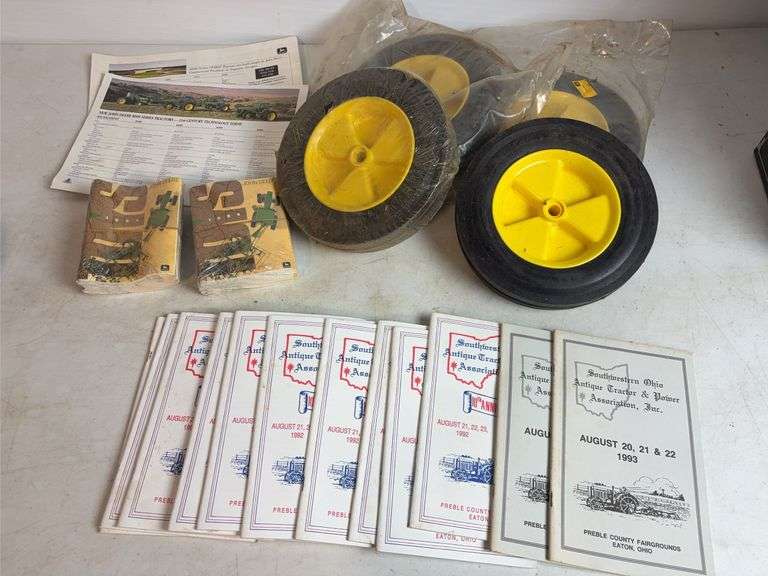 Miscellaneous John Deere items - (4) wheels, toy booklets, and more