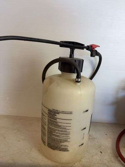 Propane tank with torch, deck sprayer, and level