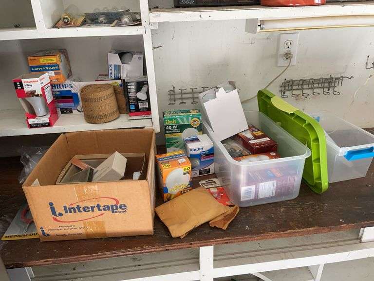 Contents of shelving including lightbulbs, screw-in hooks & more