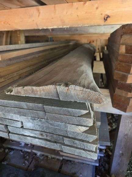 Assortment of stacked lumber. Under roof, lots of 8ft & 10ft variety of species Buyer responsible fo