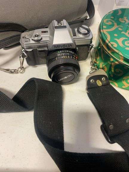 Suitcase, camera with bag, antique General Electric speaker, tin, and more