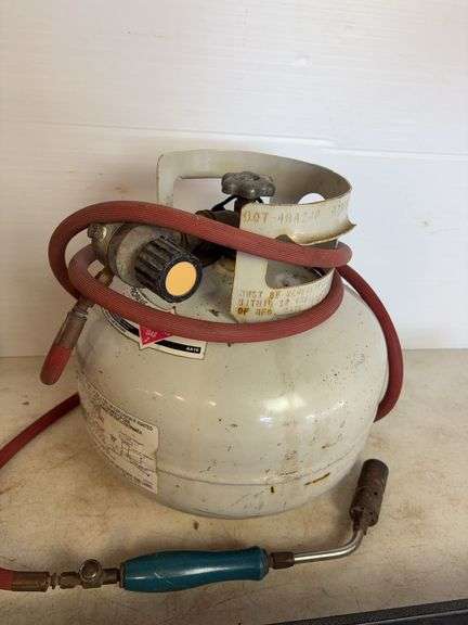 Propane tank with torch, deck sprayer, and level
