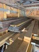 Assortment of stacked lumber. Under roof, lots of 8ft & 10ft variety of species Buyer responsible fo