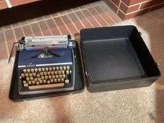 Antique Adler typewriter with case