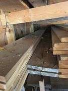 Assortment of stacked lumber. Under roof, lots of 8ft & 10ft variety of species Buyer responsible fo